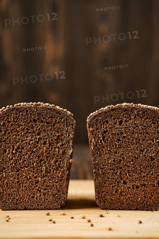 Closeup view of fresh rye brown bread on wooden cutting board