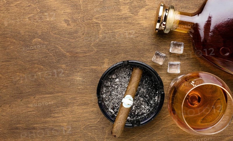 Flat lay cognac cigar with copy space