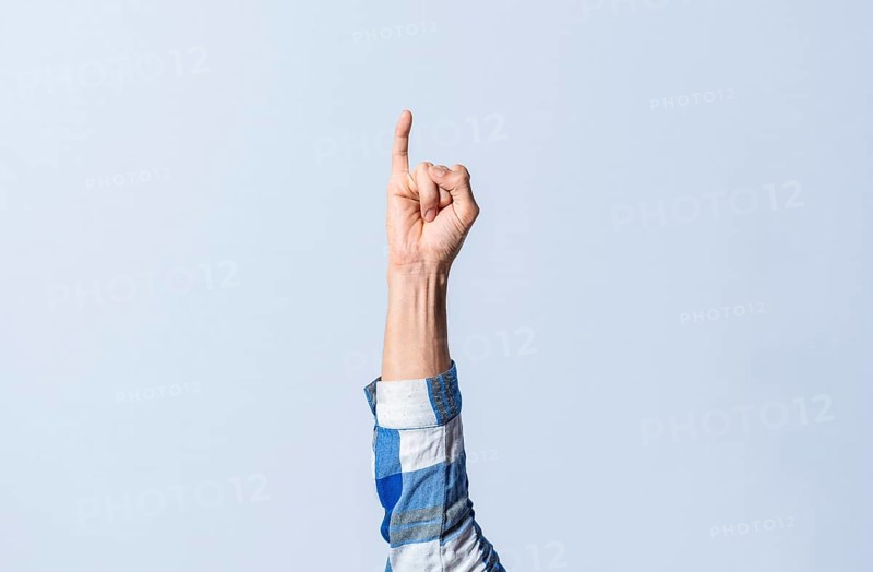 Hand gesturing the letter I in sign language on an isolated background. Man's hand gesturing the letter I of the alphabet isolated. Letters of the alphabet in sign language