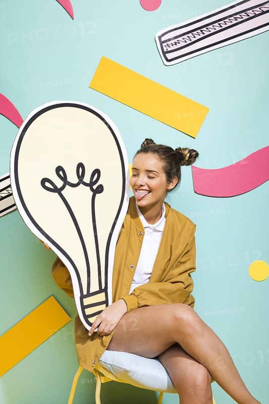 Portrait schoolgirl with big light bulb