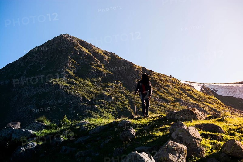 Hikers with backpacks and trekking poles walking in Turkish highland