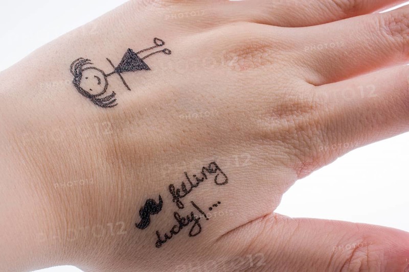 Girl figure drawn on a finger tip with black color