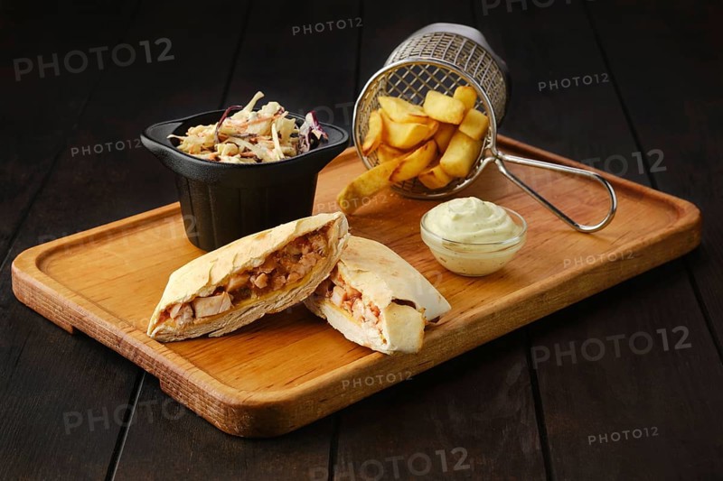 Tostada with chicken fillet served with cabbage salad and american fries on wooden tray