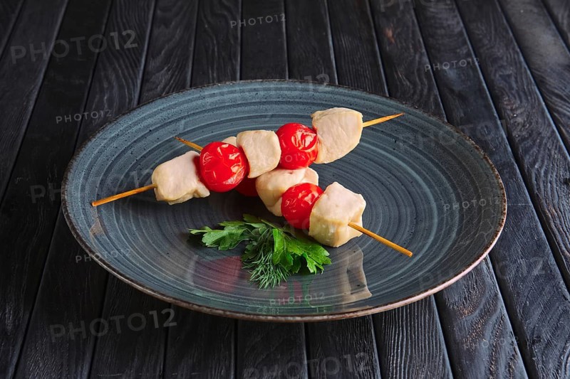 Appetizer for reception. Boiled chicken fillet and tomato cherry on skewer