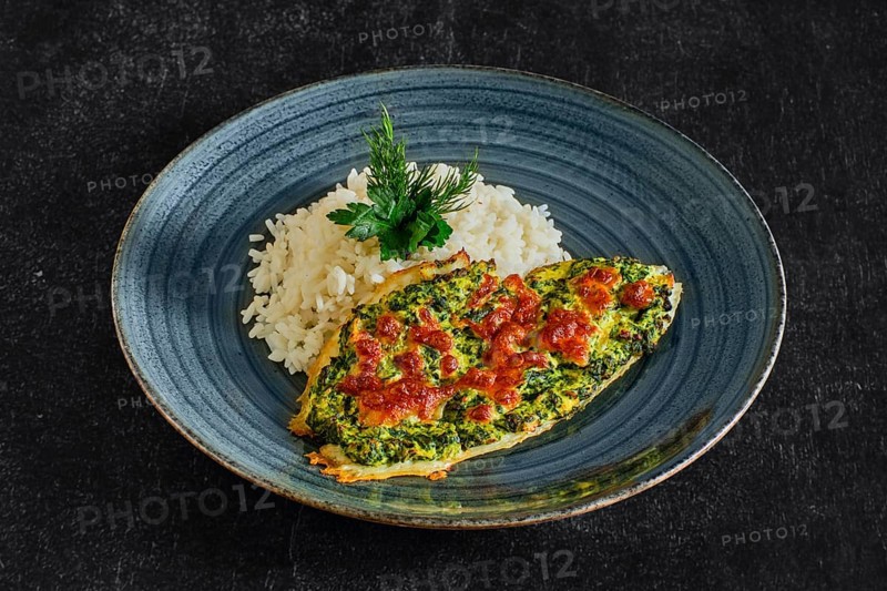 Fried fillet of white fish with spinach and cheese topping and served with rice
