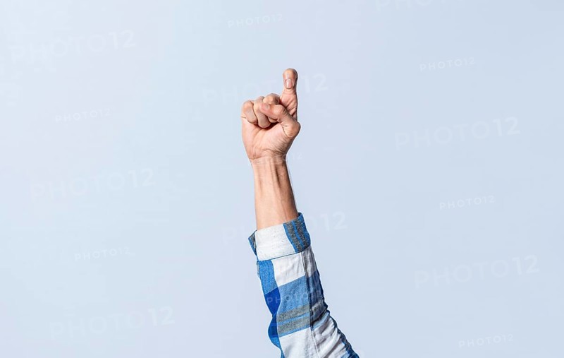 Hand gesturing the letter Z in sign language on an isolated background. Man's hand gesturing the letter Z of the alphabet isolated. Letter Z of the alphabet in sign language