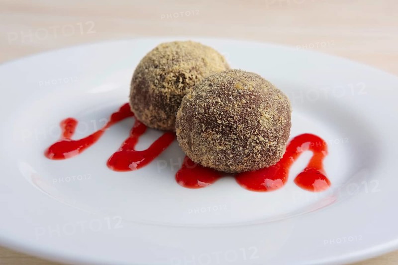 Chocolate truffles with biscuit powder. Rum balls and raspberry jam