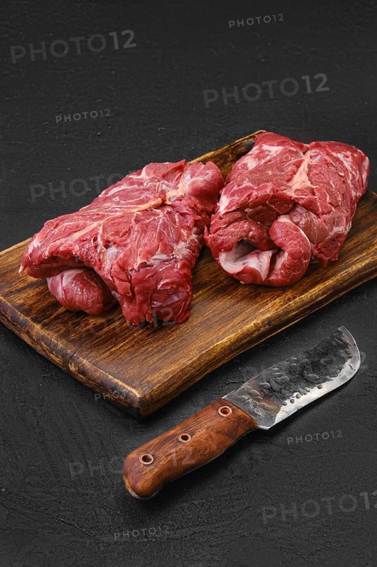 Raw rolled lamb boneless neck meat on cutting board