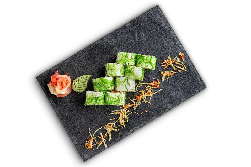 Set of rolls with wasabi and pickled ginger on stone serving board isolated on white