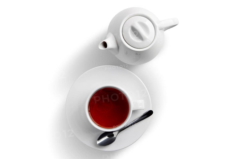 Ceramic tea cup and pot with Dilmah tea isolated on white
