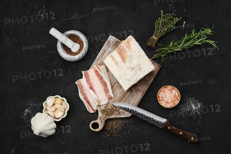 Overhead view of salted pork belly lard on cutting board