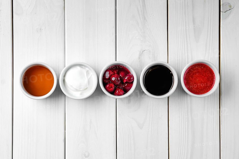 Assortment of different sauce on white wooden table