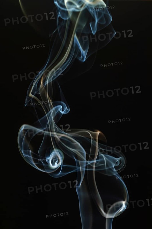 Trajectory of incense smoke in the air showing different shapes. France