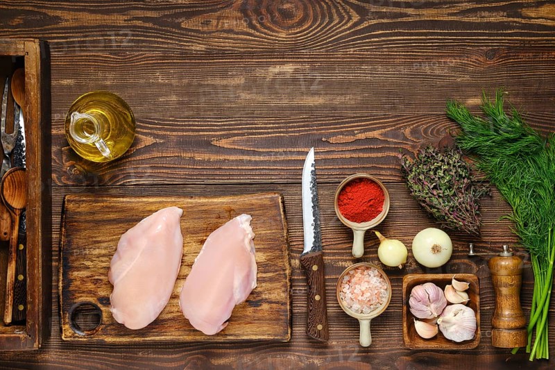 Culinary concept. Overhead view of kitchen table with chicken fillet