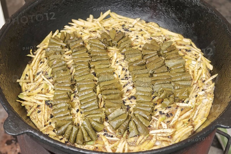 Meat and dolma in cauldron. The making of pilaf