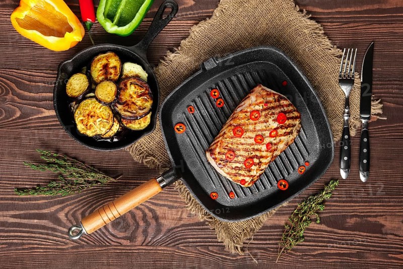 Top view of grilled striploin on grill pan and fried eggplant on wooden background