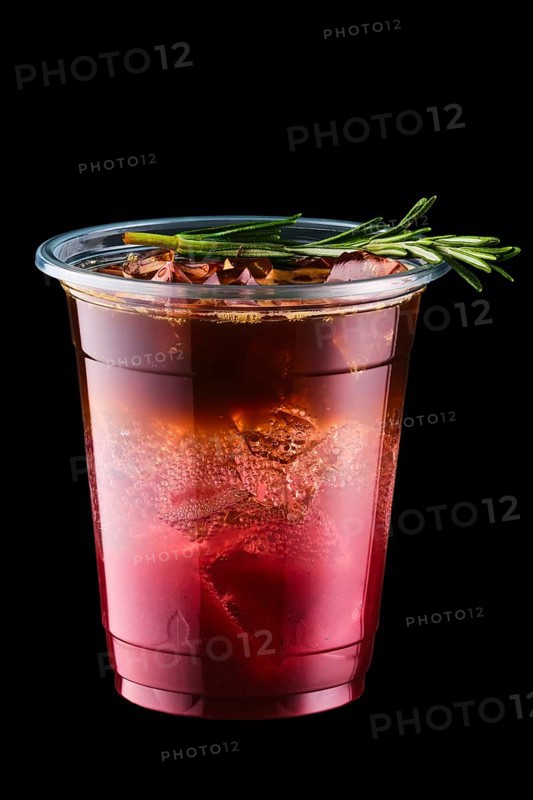Espresso tonic with cherry juice in take away cup isolated on black background