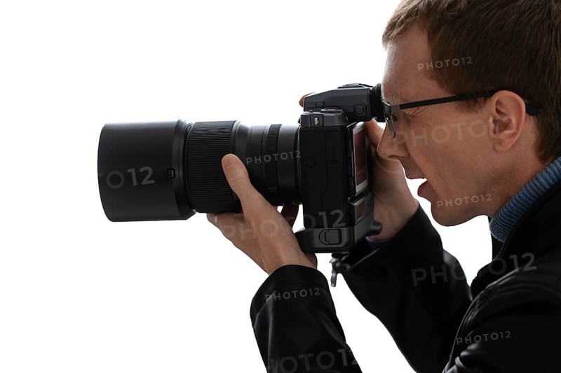 Close up portrait of photographer with camera on white background
