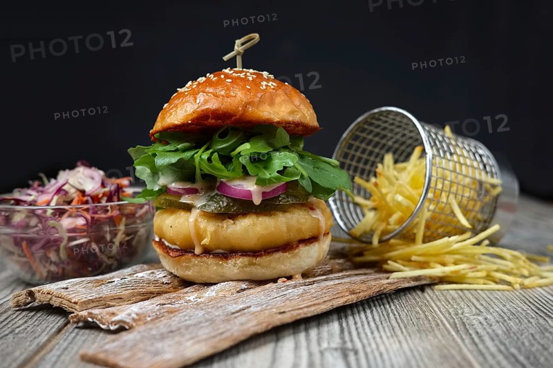 Fishburger on the wooden plates with cheese