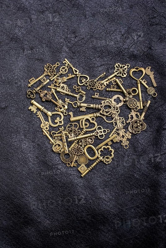 Retro style metal keys form a heart shape on black