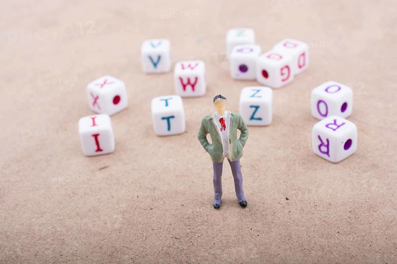 Figurine standing in front of the colorful alphabet letter cubes