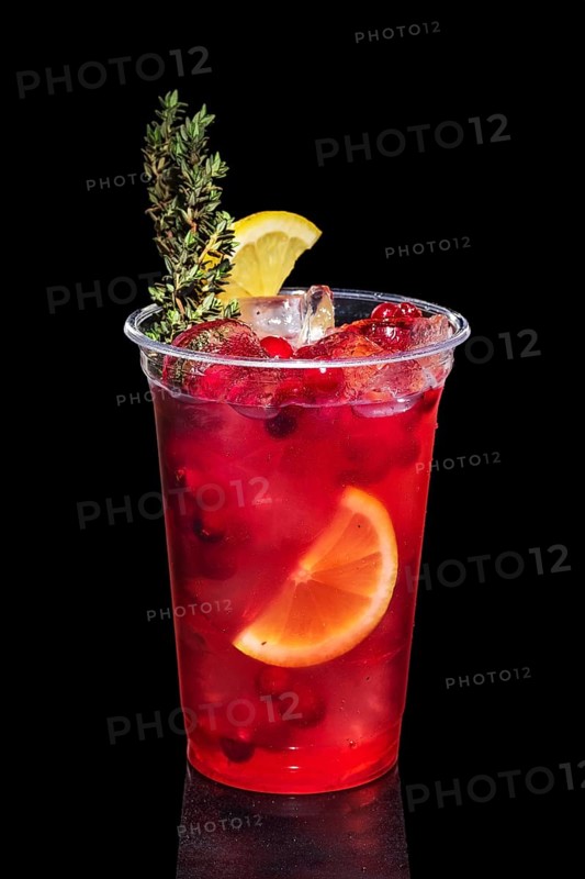 Cranberry vodka cocktail with lemon and rosemary isolated on black