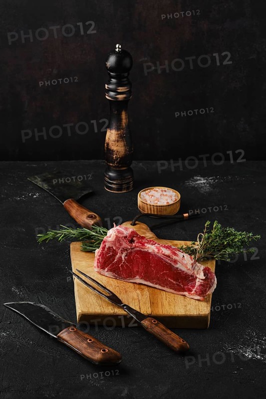 Raw strip steak boneless on dark background