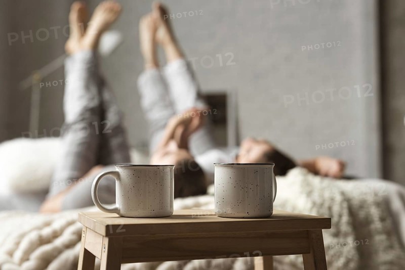 Coffee cups table with couple bed
