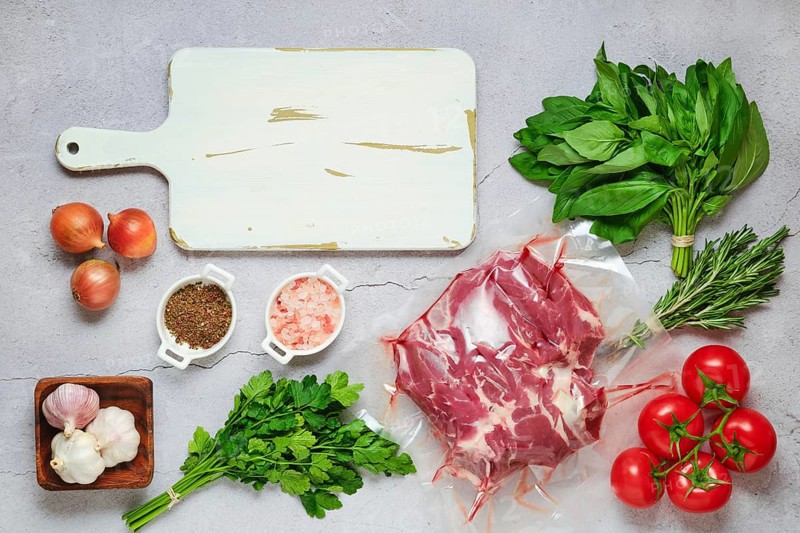 Vacuum sealed lamb shoulder with ingredients for cooking