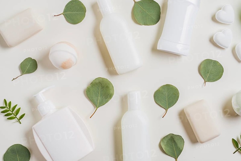 Overhead view cosmetics products soap bath bomb green leaves