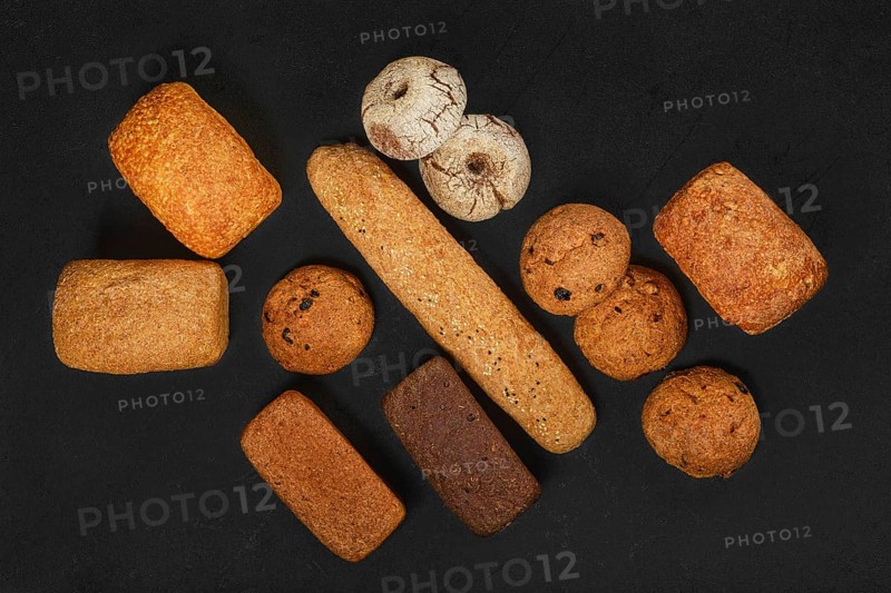 Top view of assortment of artisan bread made of different types of grain with different shapes