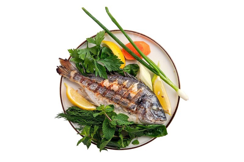 Fried dorada on plate isolated on white background