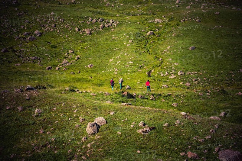 Hikers with backpacks and trekking poles walking in Turkish highland