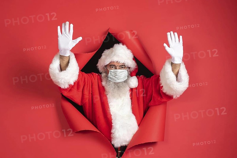 Man santa costume with medical mask coming out paper