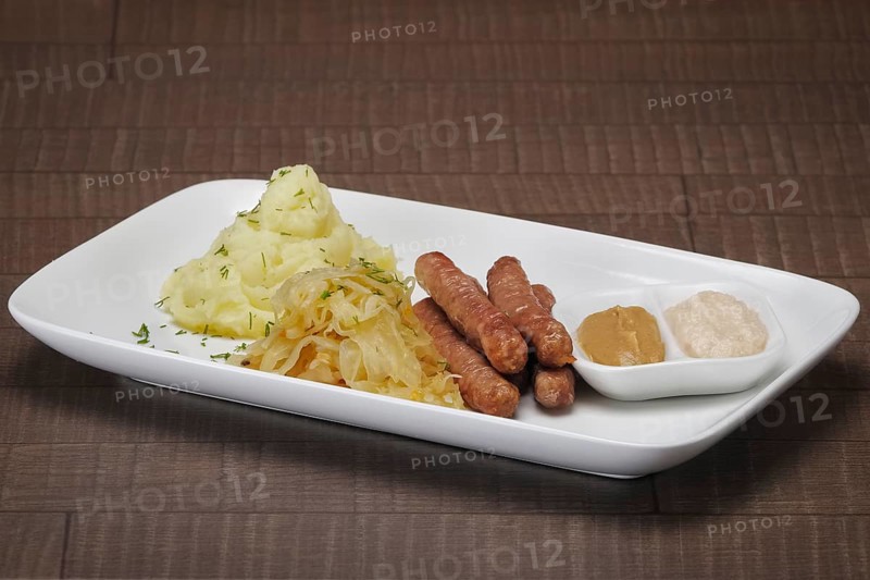 Homemade sausage with mashed potato and sauerkraut and mustard with horseradish