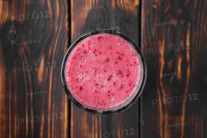 Top view of black currant and raspberries smoothie