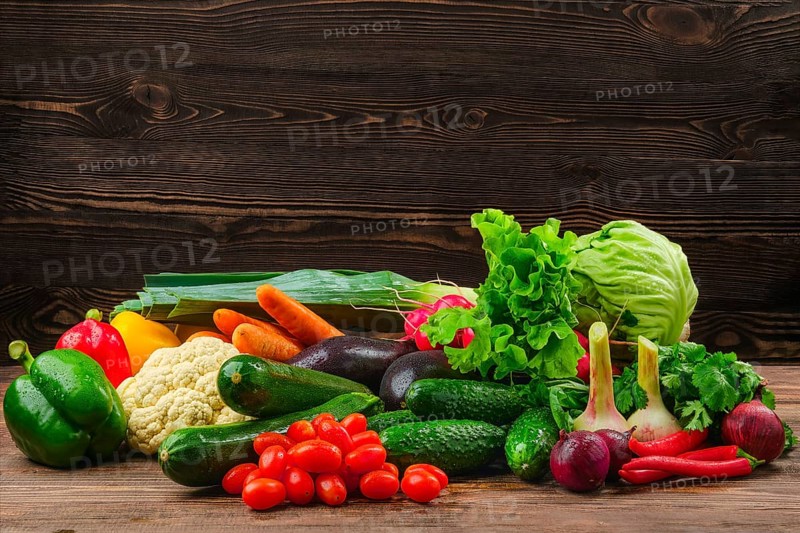 Assortment of fresh vegetables on dark wooden background