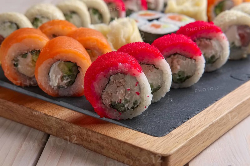 Big set of rolls served on stone plate