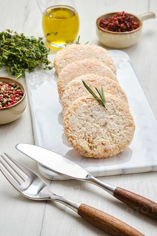 Semifinished chicken cutlet in breading ready for frying