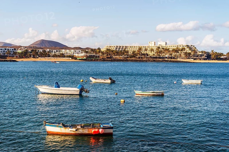 View of the resort town named Costa Teguise with boats on the foreground