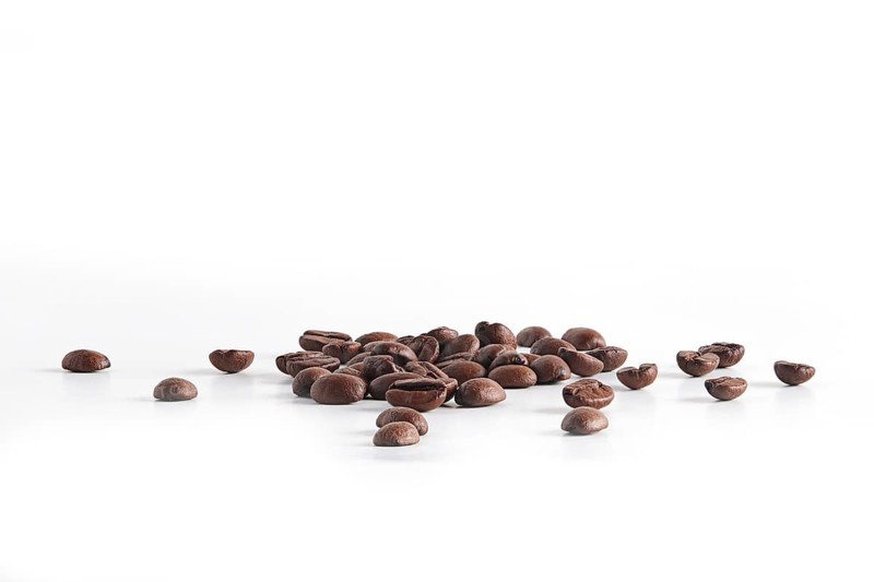 Coffee beans scattered on white background