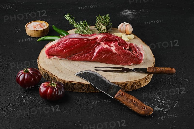 Raw top sirloin beef steak on wooden cutting board