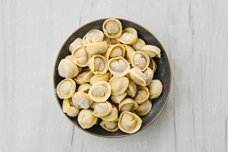 Top view of homemede meat dumplings on white wooden table