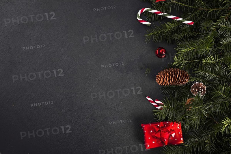 Fir twigs near candy canes gift box