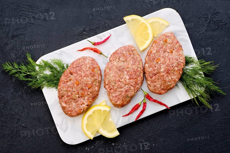 Uncooked cutlet with minced beef meat and cabbage ready for cooking