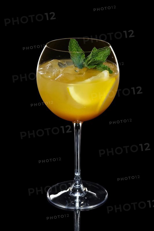Cild lemon cocktail with a sparkling wine with ice in wine glass isolated on black