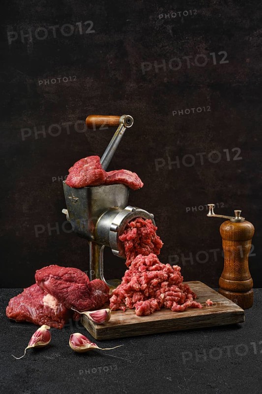Making minced beef meat with oldfashioned meat grinder