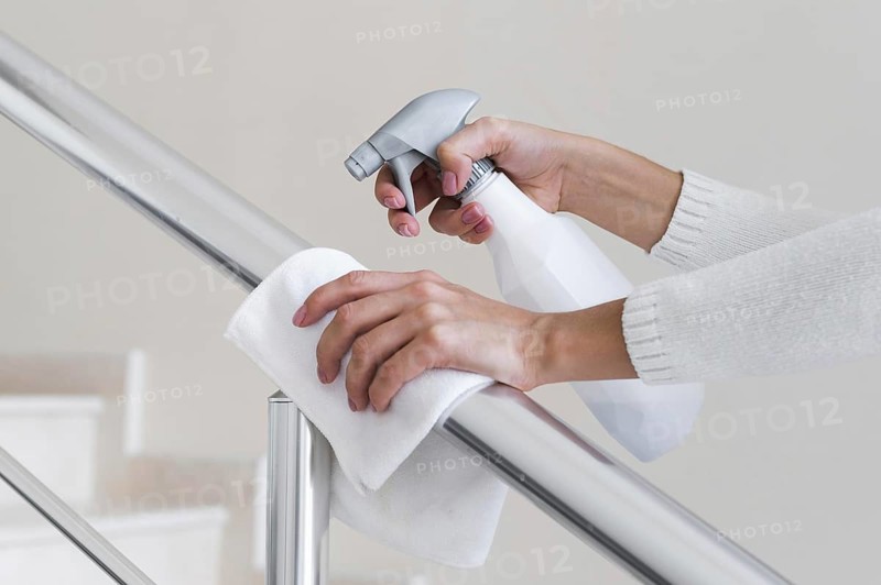 Hands disinfecting hand rail