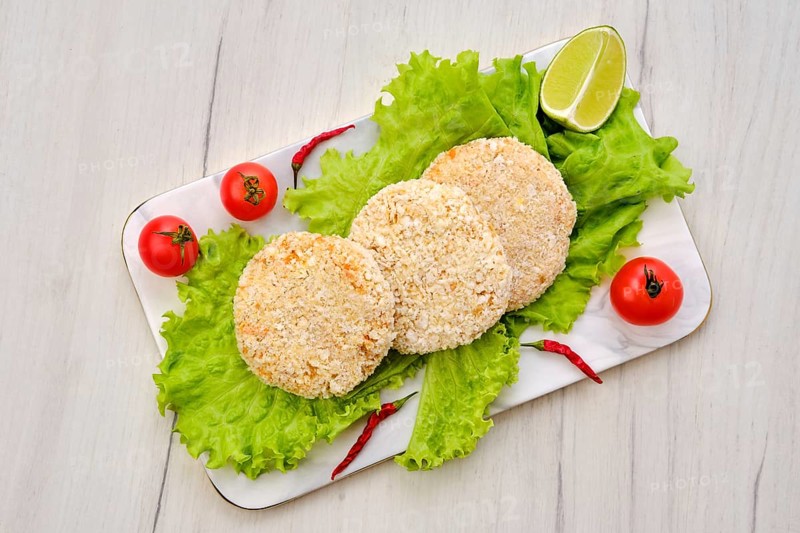 Top view of trout meat cutlet in breading