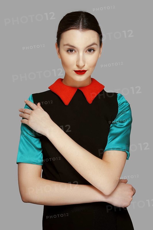 Pretty young fashion model with tan skin and red mat lips. Beauty shoot